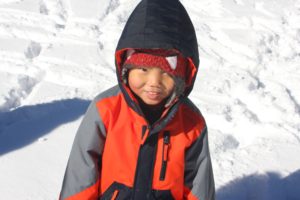 little boy playing in the snow: the miracle of adoption