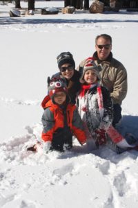 family playing in the snow: the miracle of adoption