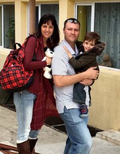 mom and dad leaving orphanage with young child