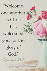 Flowers in a vase with text overlay from Romans 15:7