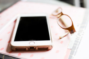 phone with glasses on notebook
